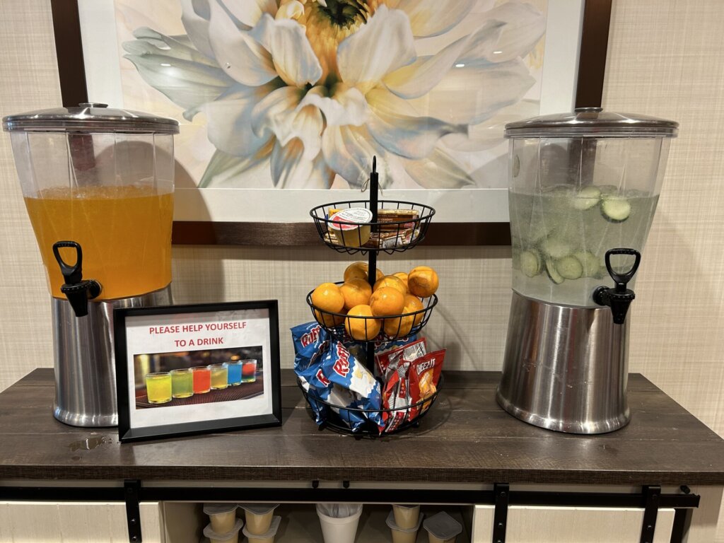 Hydration station is stocked with fresh fruit, Cheez-it crackers, Ruffles, Cucumber water, and many treats. This station helps encourage residents to eat and drink regularly.